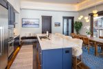 The oversized kitchen island provides seating for four in cozy, custom sheep skin barstools.